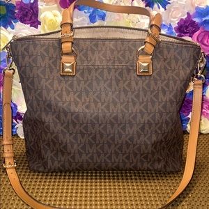 Large MK monogram Michael Kors tote with handles and removable crossbody strap.